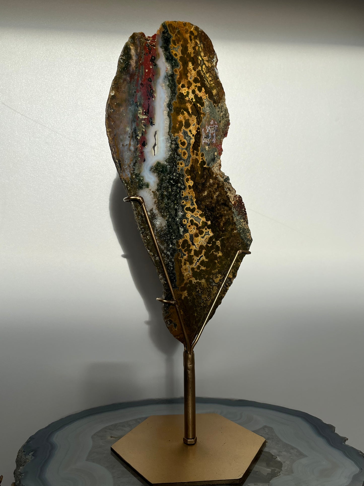 Multicoloured River Jasper Slab with Dendritic Inclusions on Rotating Gold Coloured Stand