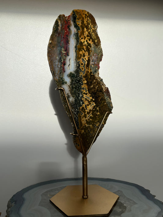 Multicoloured River Jasper Slab with Dendritic Inclusions on Rotating Gold Coloured Stand