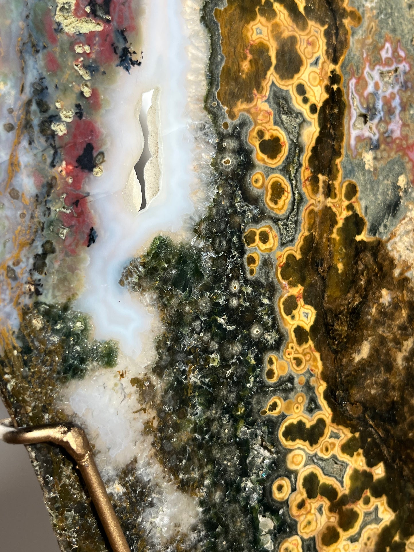 Multicoloured River Jasper Slab with Dendritic Inclusions on Rotating Gold Coloured Stand