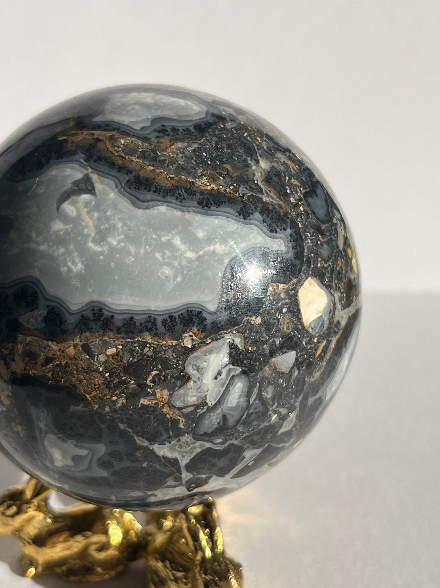 Decorative crystal ball with gold base on a white background