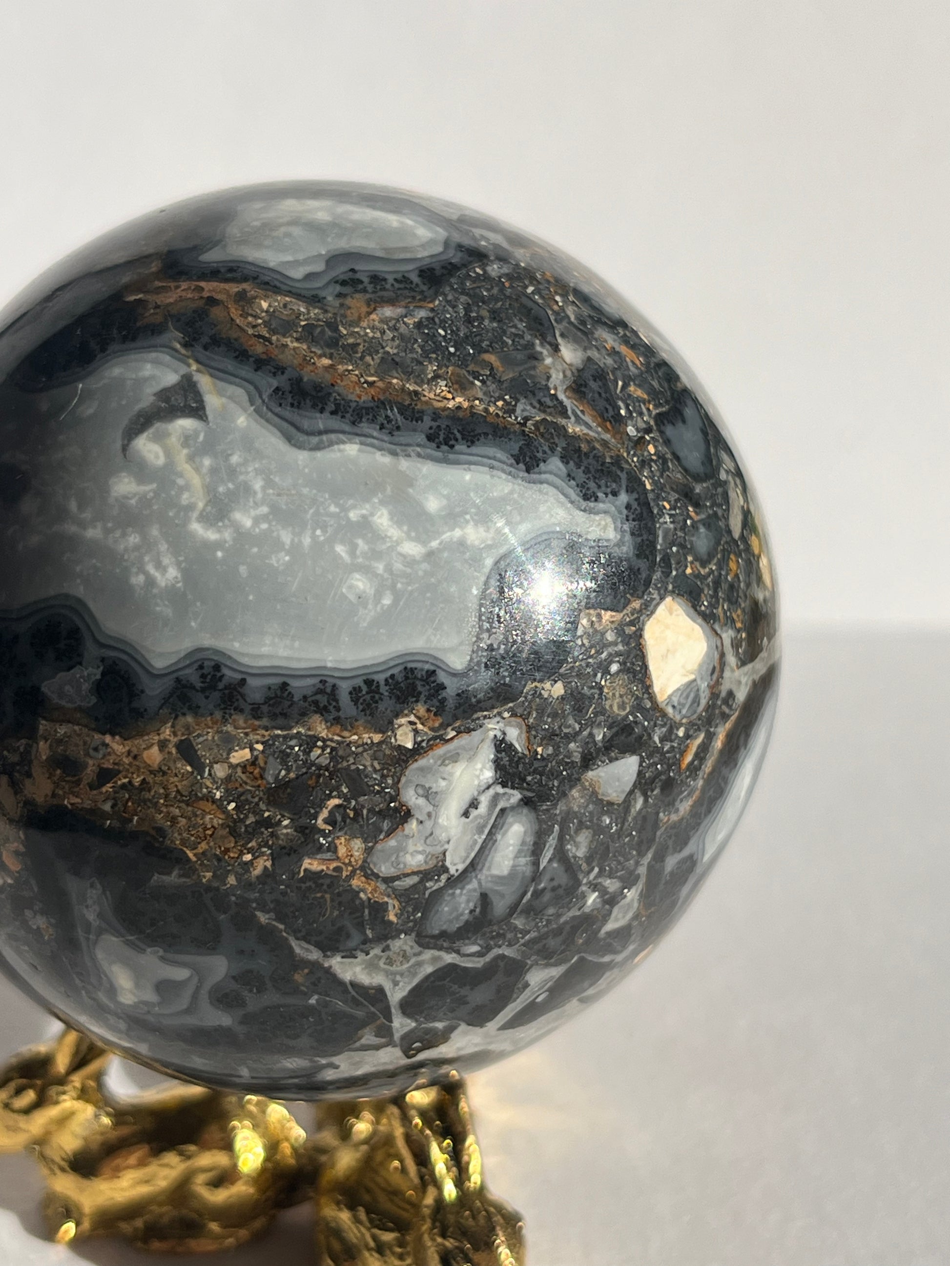 Decorative crystal ball with gold base on a white background