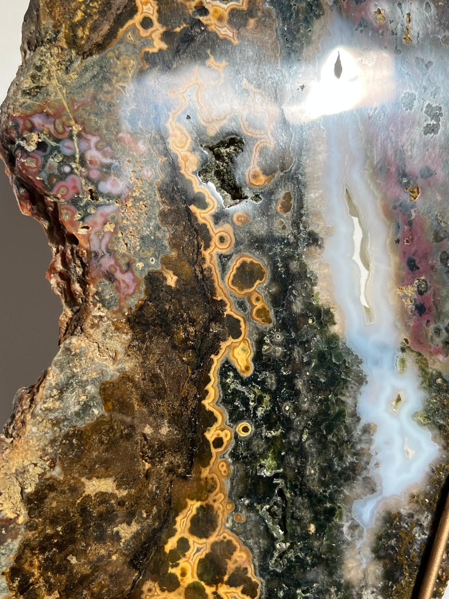 Multicoloured River Jasper Slab with Dendritic Inclusions on Rotating Gold Coloured Stand