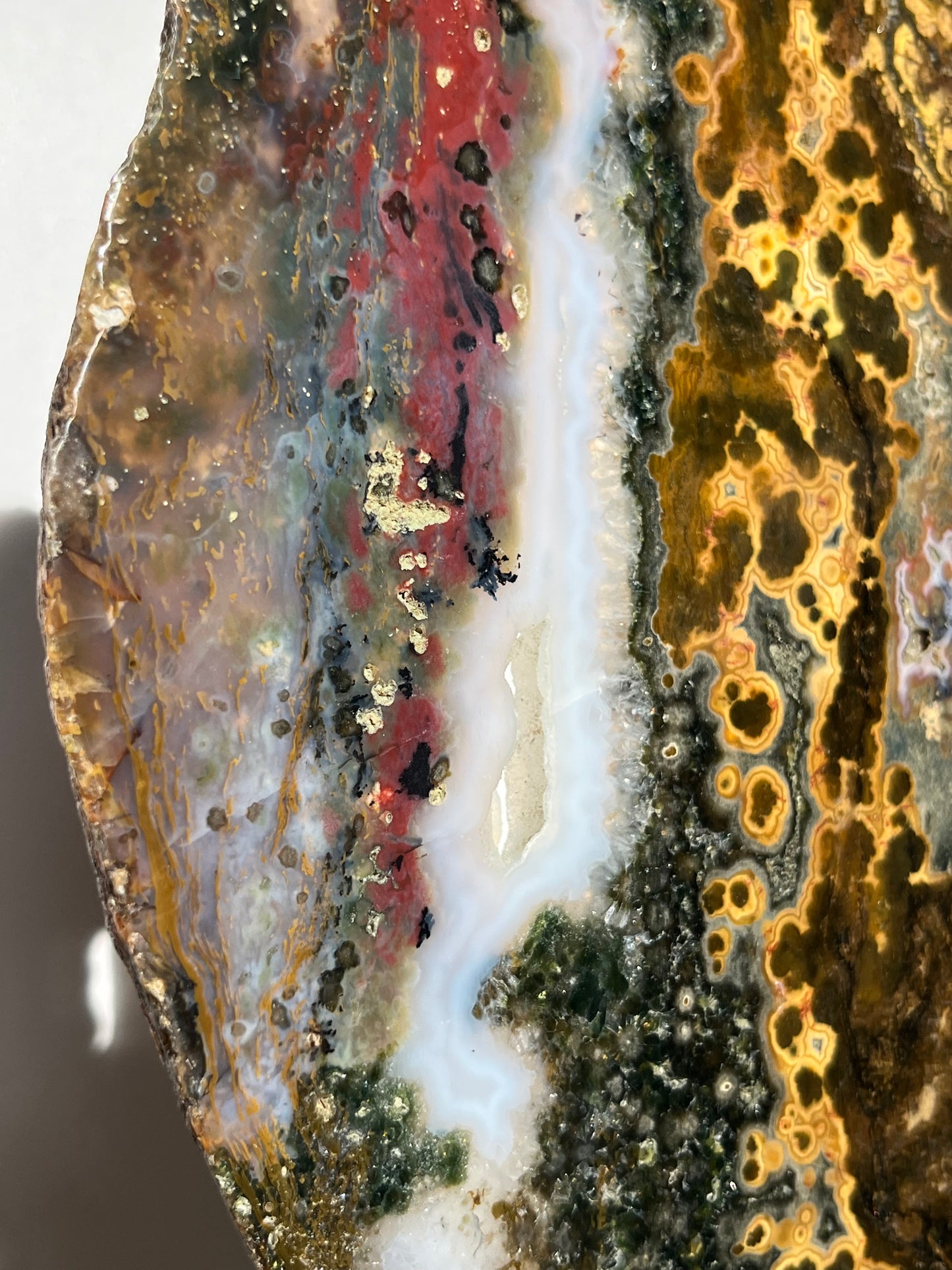 Multicoloured River Jasper Slab with Dendritic Inclusions on Rotating Gold Coloured Stand